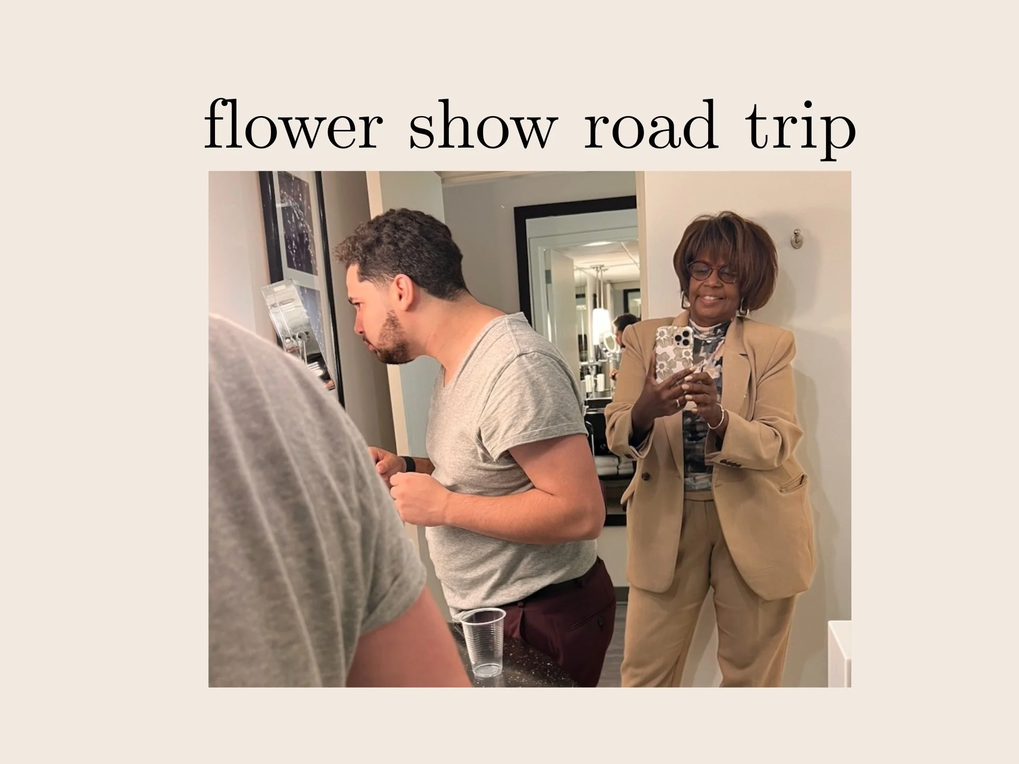 Alexavier and Trina Davis of Gifts of Gifts of Flowers designed by TA  located in Feeding Hills, MA in a room with mirrors and framed pictures on the wall, during a flower show road trip event.