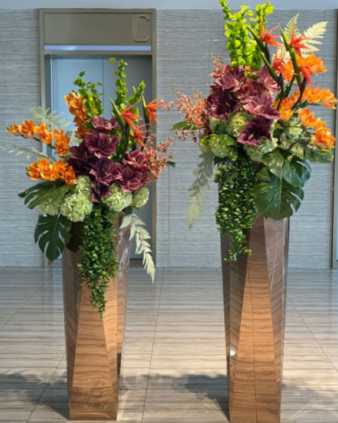 gifts of flowers two lobby displays of flowers on tall geometric shaped stands