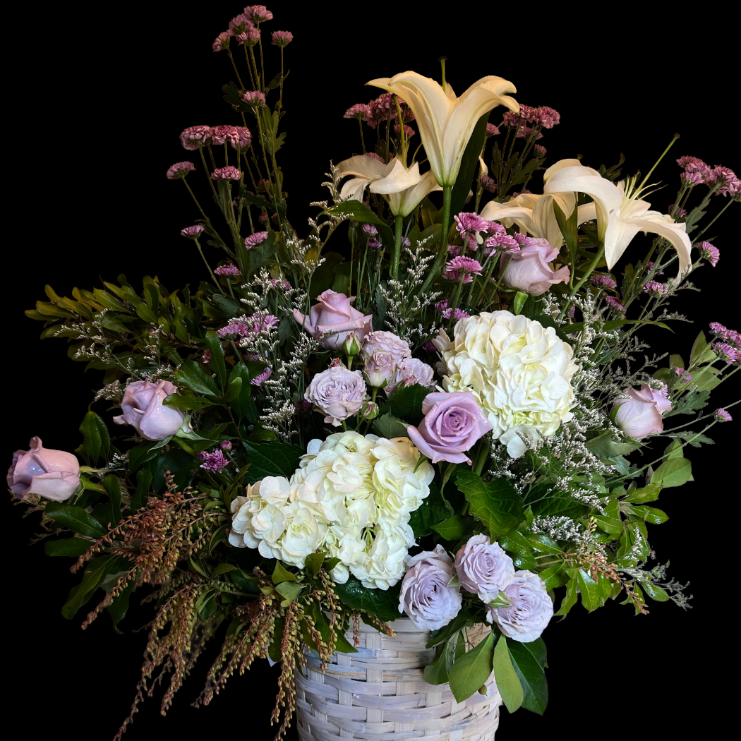 Quiet Grace sympathy flower basket with lavender roses and pink lilies, designed by Gifts of Flowers TA in Feeding Hills MA