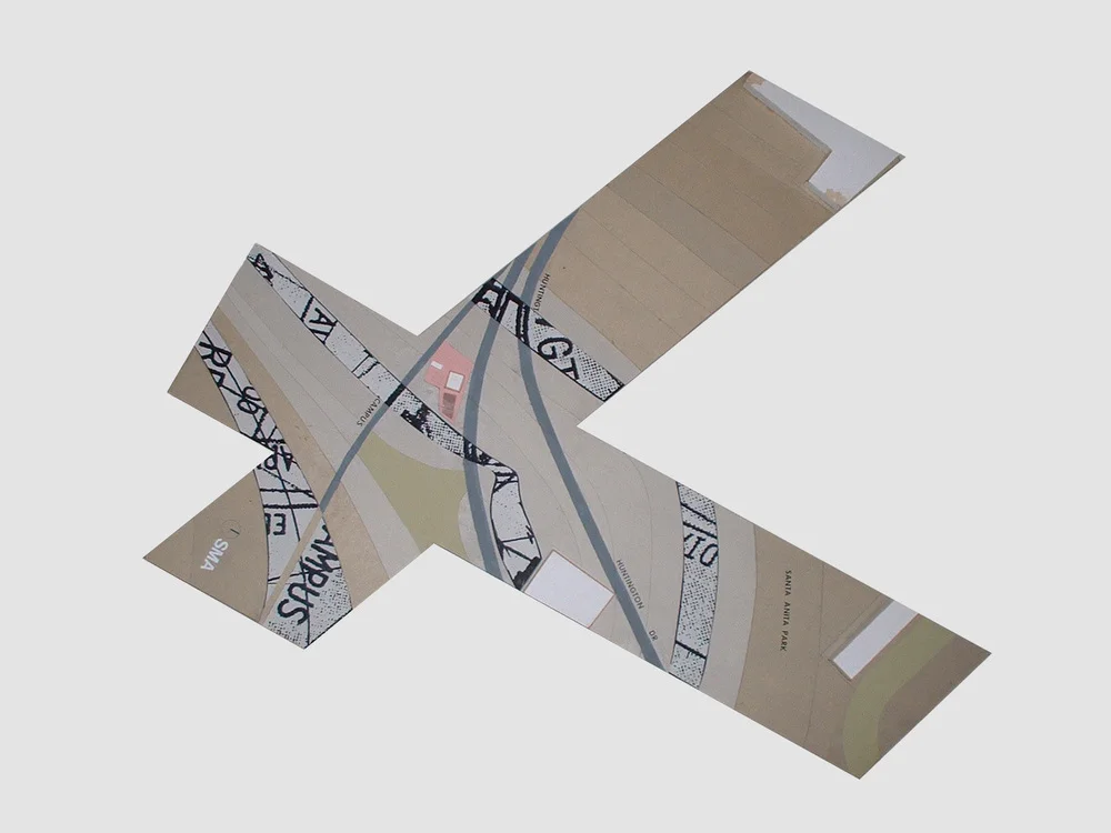 A set of map pieces arranged in a cross shape showing streets, buildings, and landmarks.