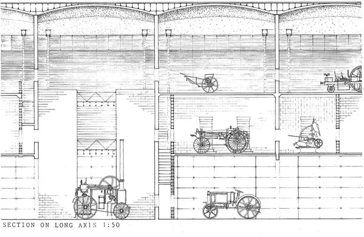 Technical drawing of a building section showing early steam-powered tractors and machinery.