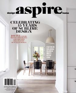 Cover of Aspire magazine featuring a modern dining room with a white table, chairs, and a hanging pendant light, celebrating 15 years of design.