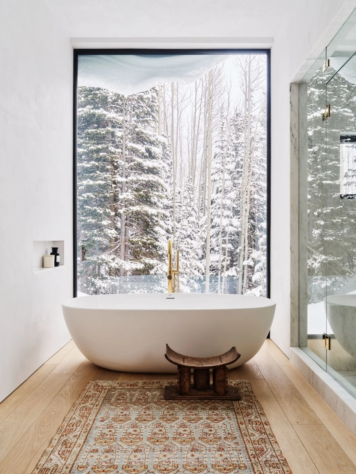 Park City Nest Residence serene bathtub with scenic window of snow designed by Sparano + Mooney Architectur