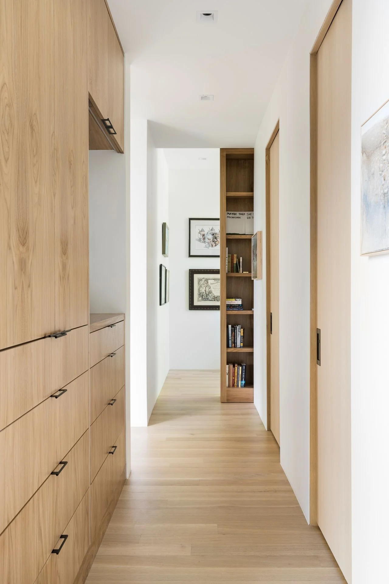 Bright cedar hallway with bookshelf and drawers designed by Sparano + Mooney Architecture