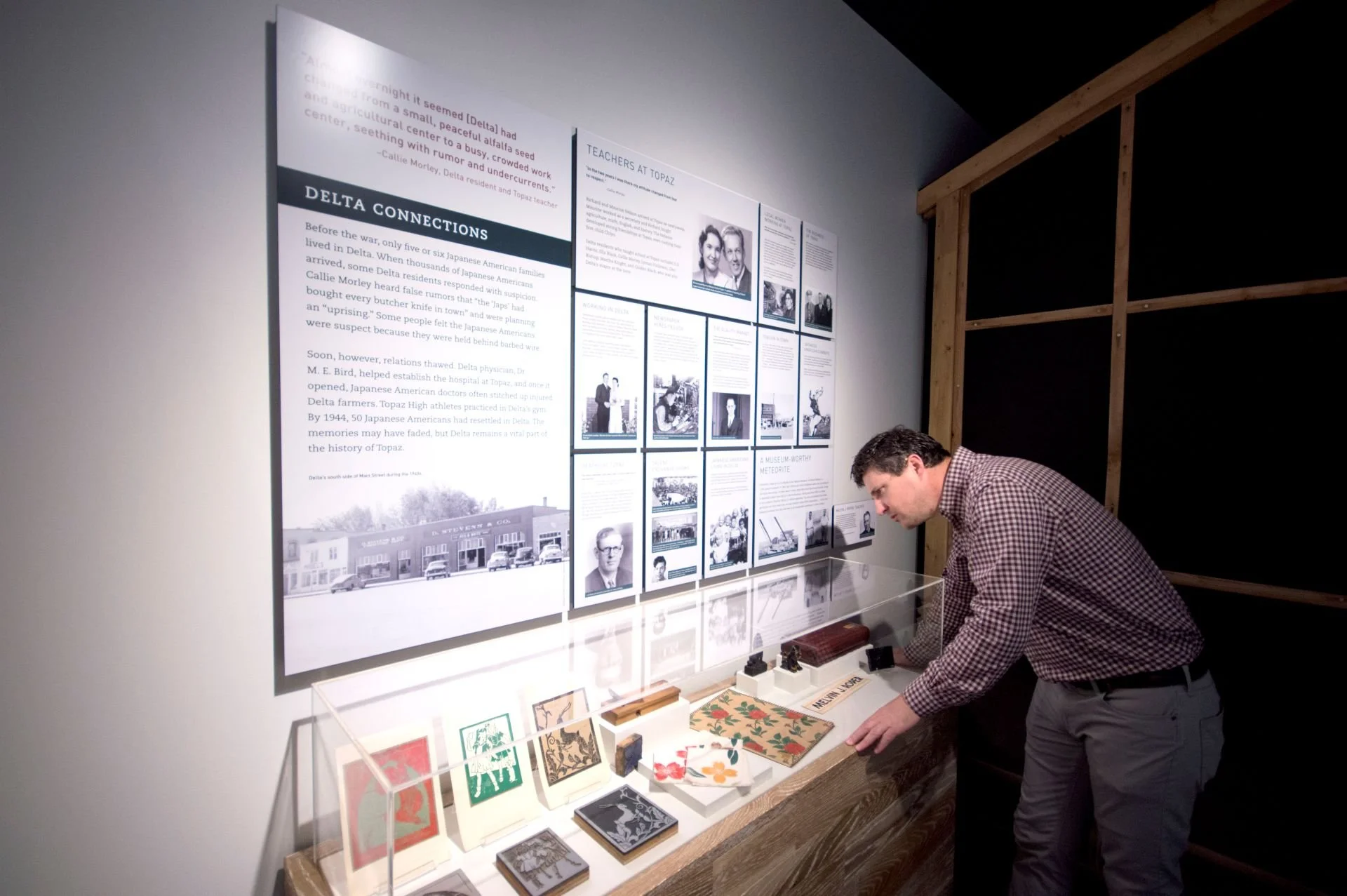 Man observing Topaz Museum exhibit designed by Sparano + Mooney Architecture
