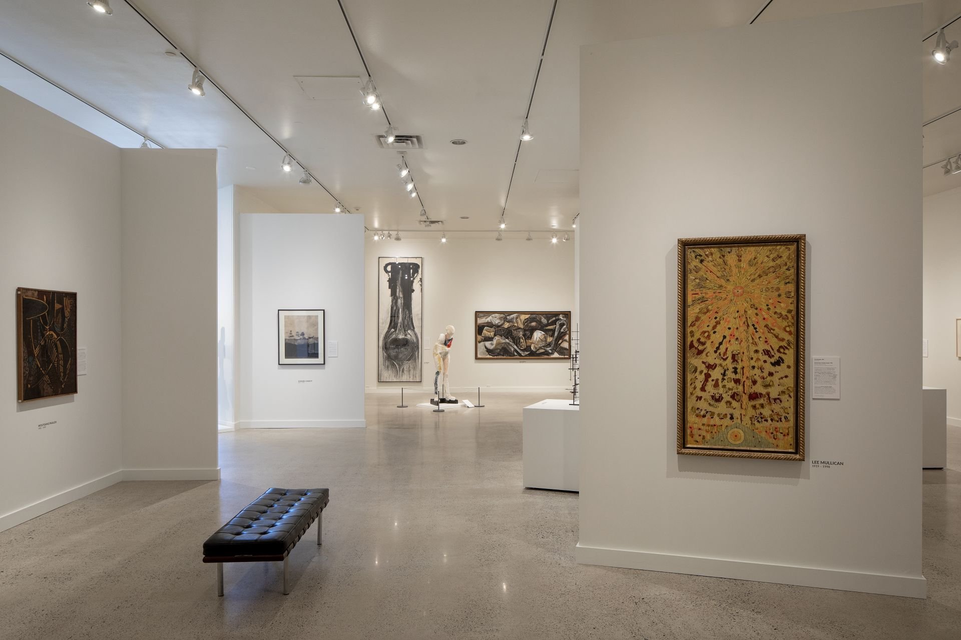 Concrete floor and white gallery with large modern art designed by Sparano + Mooney Architecture in Utah