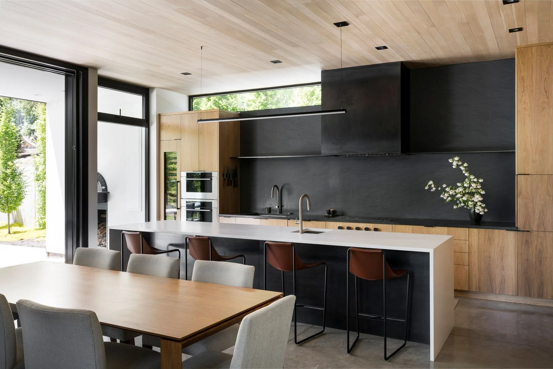 Dining and kitchen space connecting to exterior patio designed by Sparano + Mooney Architecture.