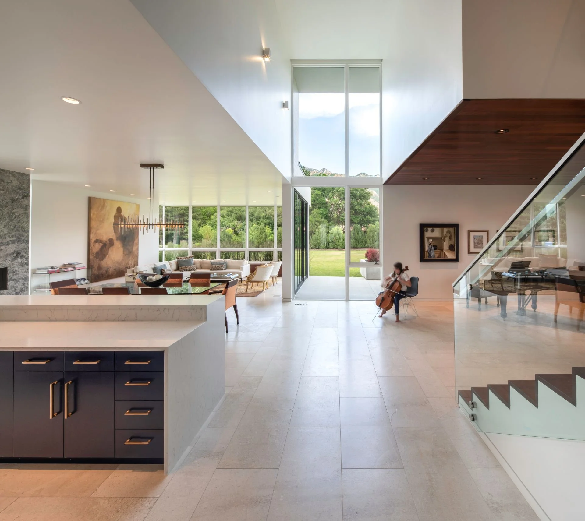 Woman playing cello in open living space designed by Sparano + Mooney Architecture.
