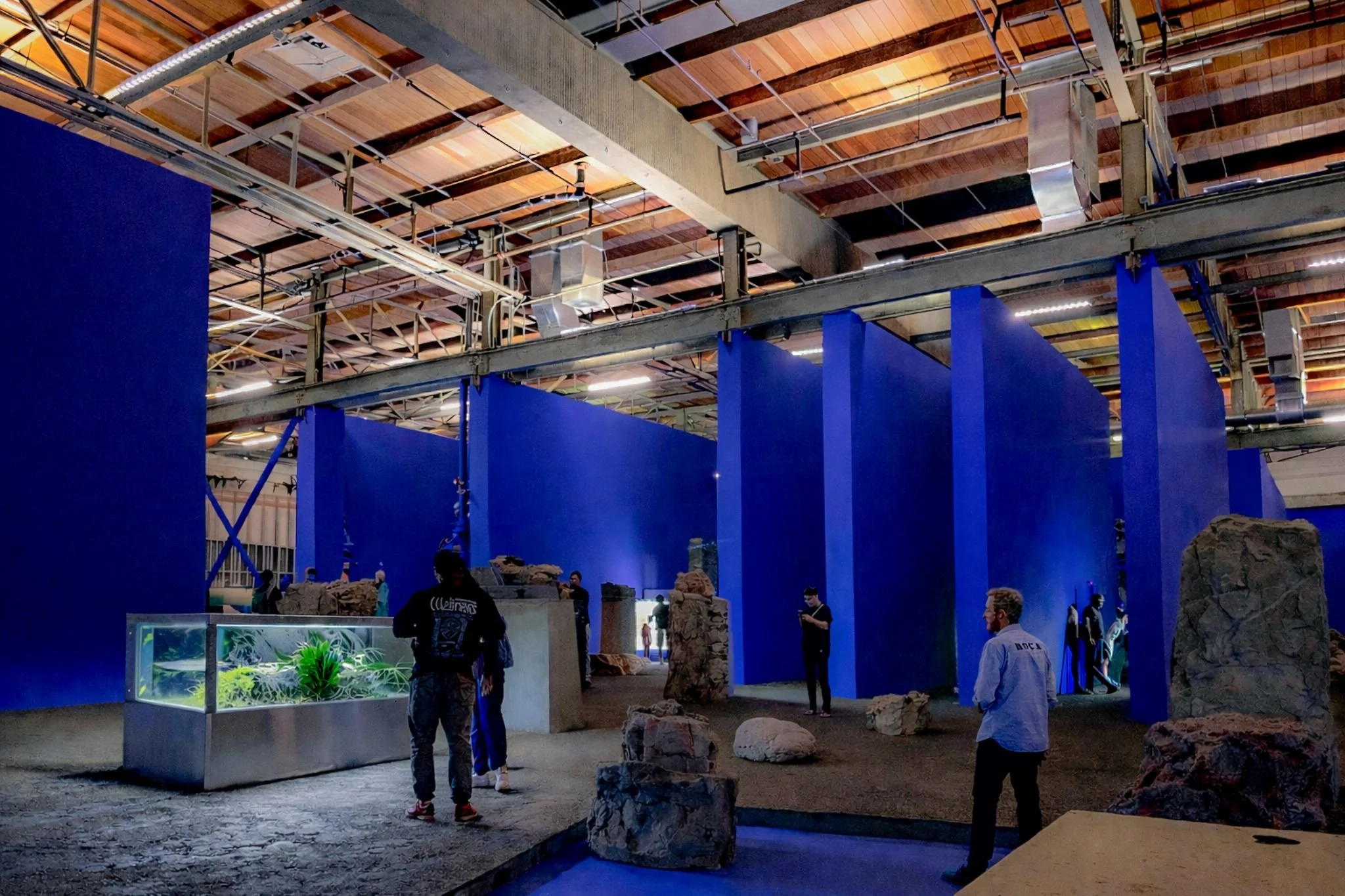 View of Adrian Villar Rojas MoCA installation Theater of Disappearance with large blue walls and boulders designed by Sparano + Mooney Architecture