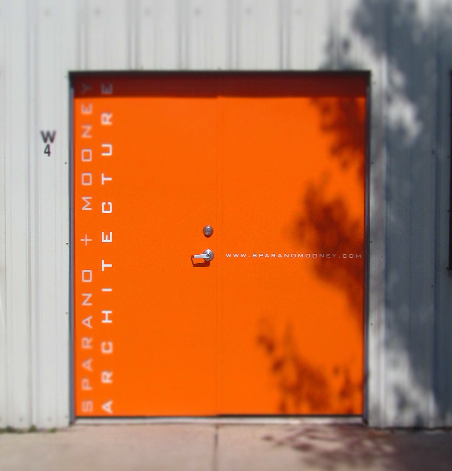 Modern orange metal entrance door for Sparano + Mooney Architecture Los Angeles office renovation