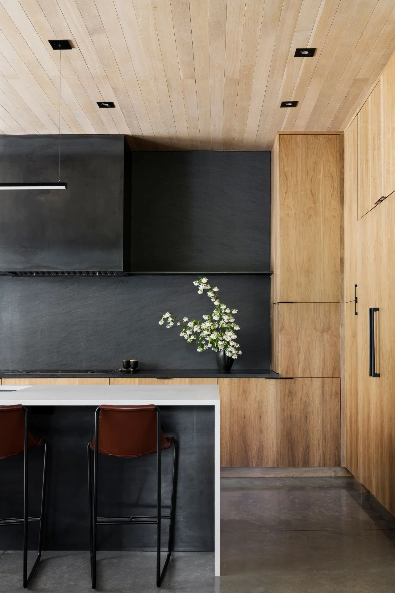 Modern dark stone and wood kitchen designed by Sparano + Mooney Architecture