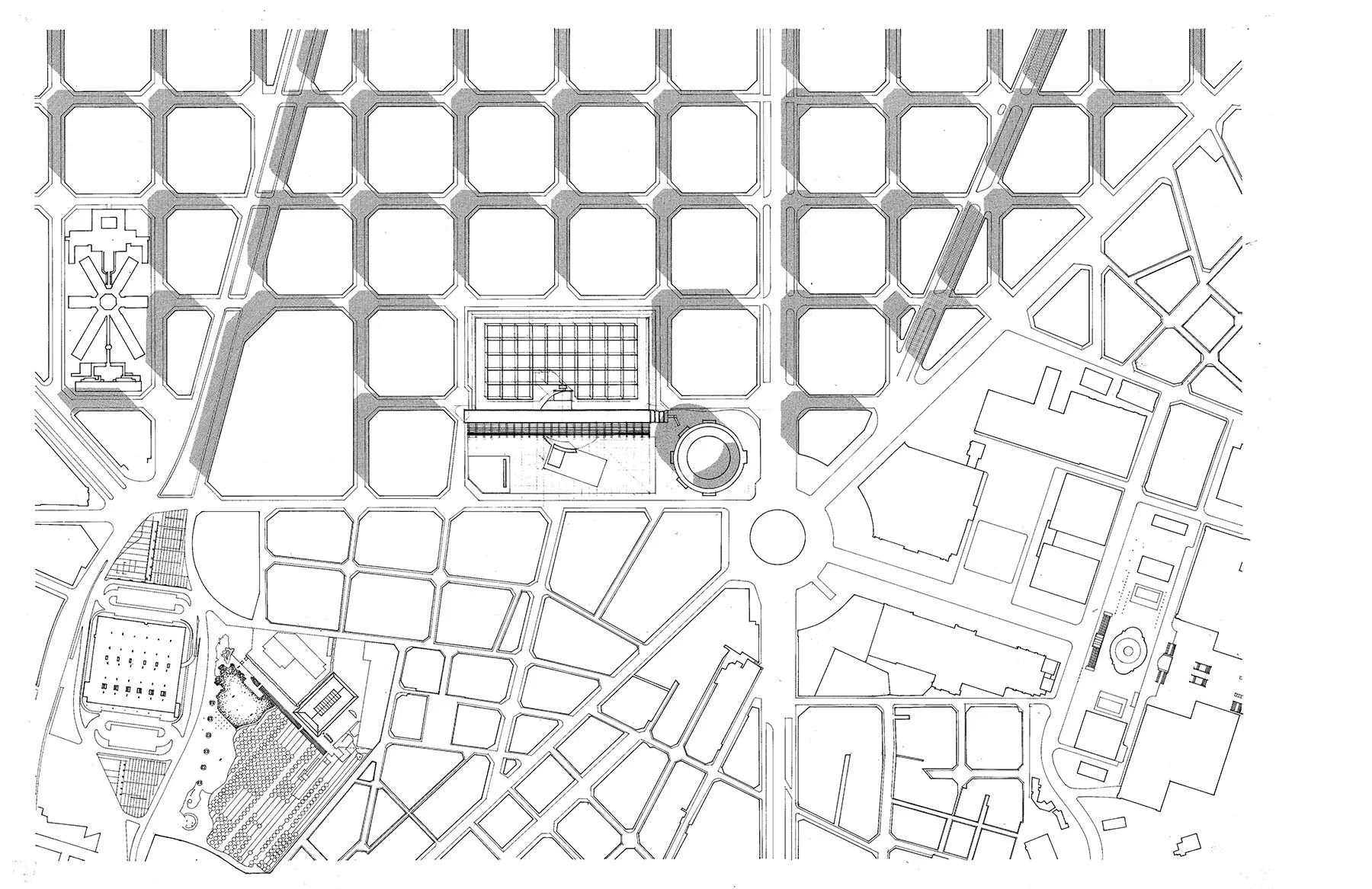 Black and white architectural site plan showing a grid pattern of buildings and streets, with various open spaces and a roundabout at the center.