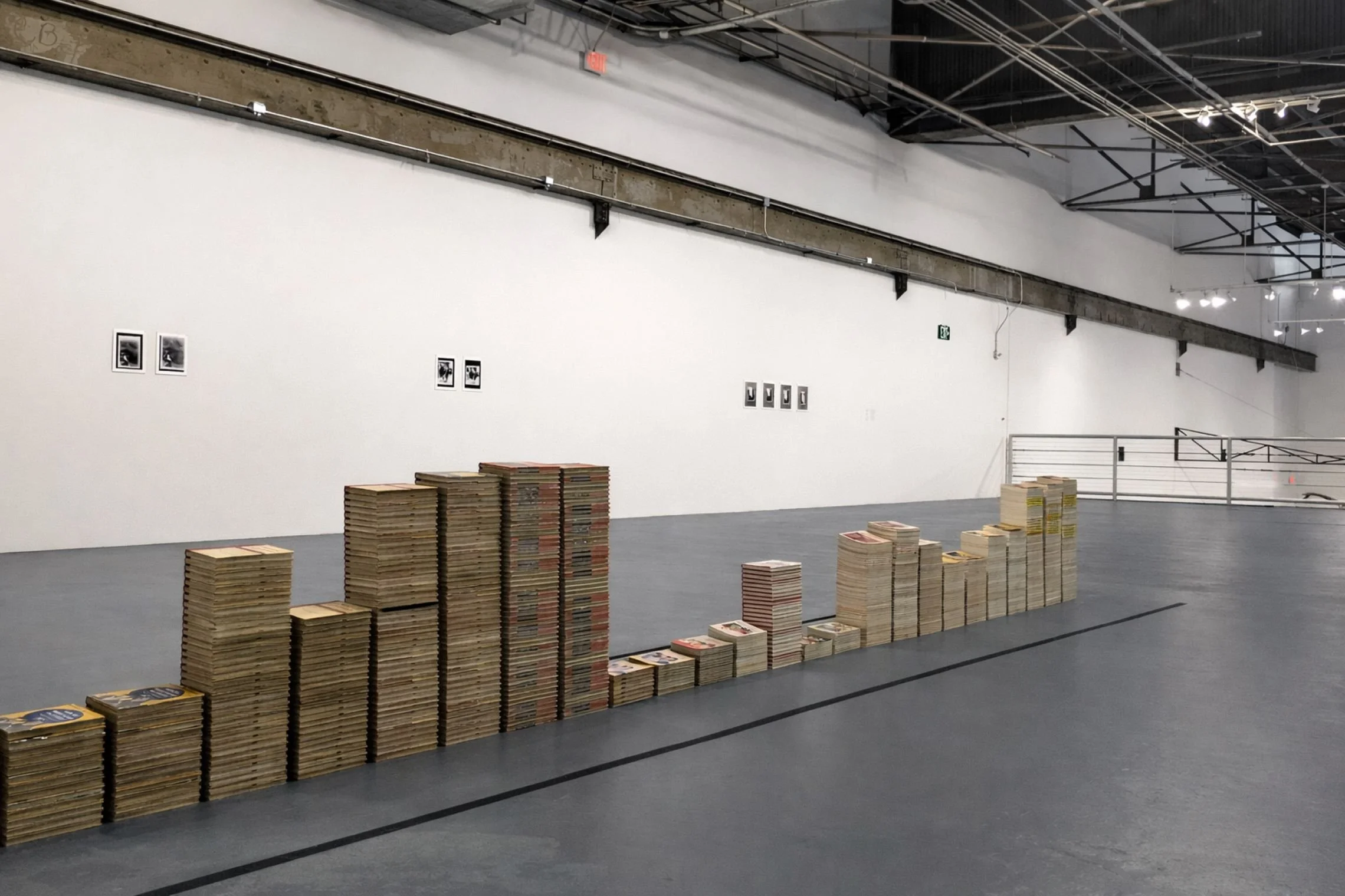 MoCA installation by Leonard consisting of hundreds of vintage copies of the same Kodak instruction book stacked in varying heights designed by Sparano + Mooney Architecture