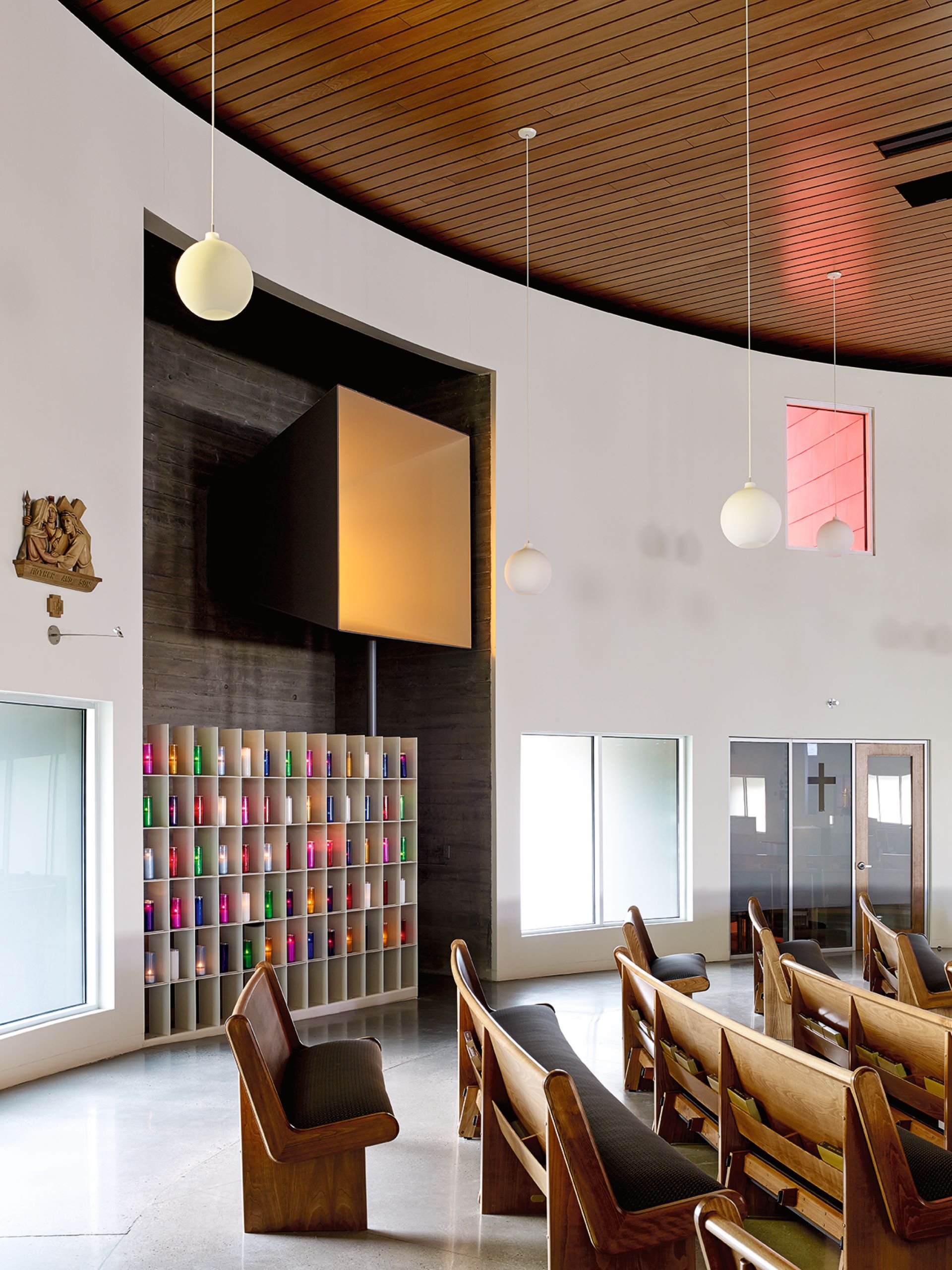 Recessed sanctuary with large glowing inset square window of Utah church designed by Sparano + Mooney Architecture