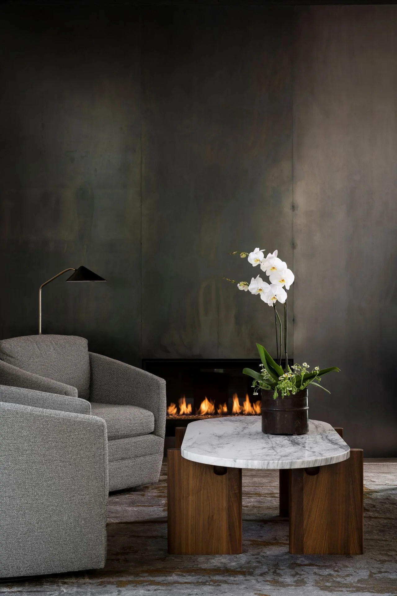 Blackened steel floor to ceiling fireplace in contemporary living room designed by Sparano + Mooney Architecture.