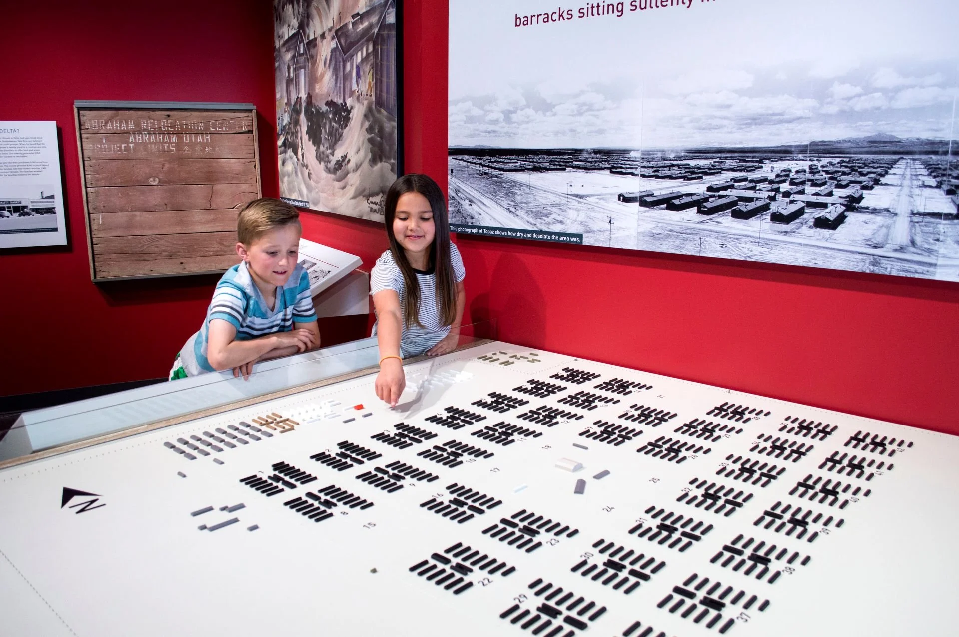 Children interacting with barrack exhibit in Topaz Museum designed by Sparano + Mooney Architecture