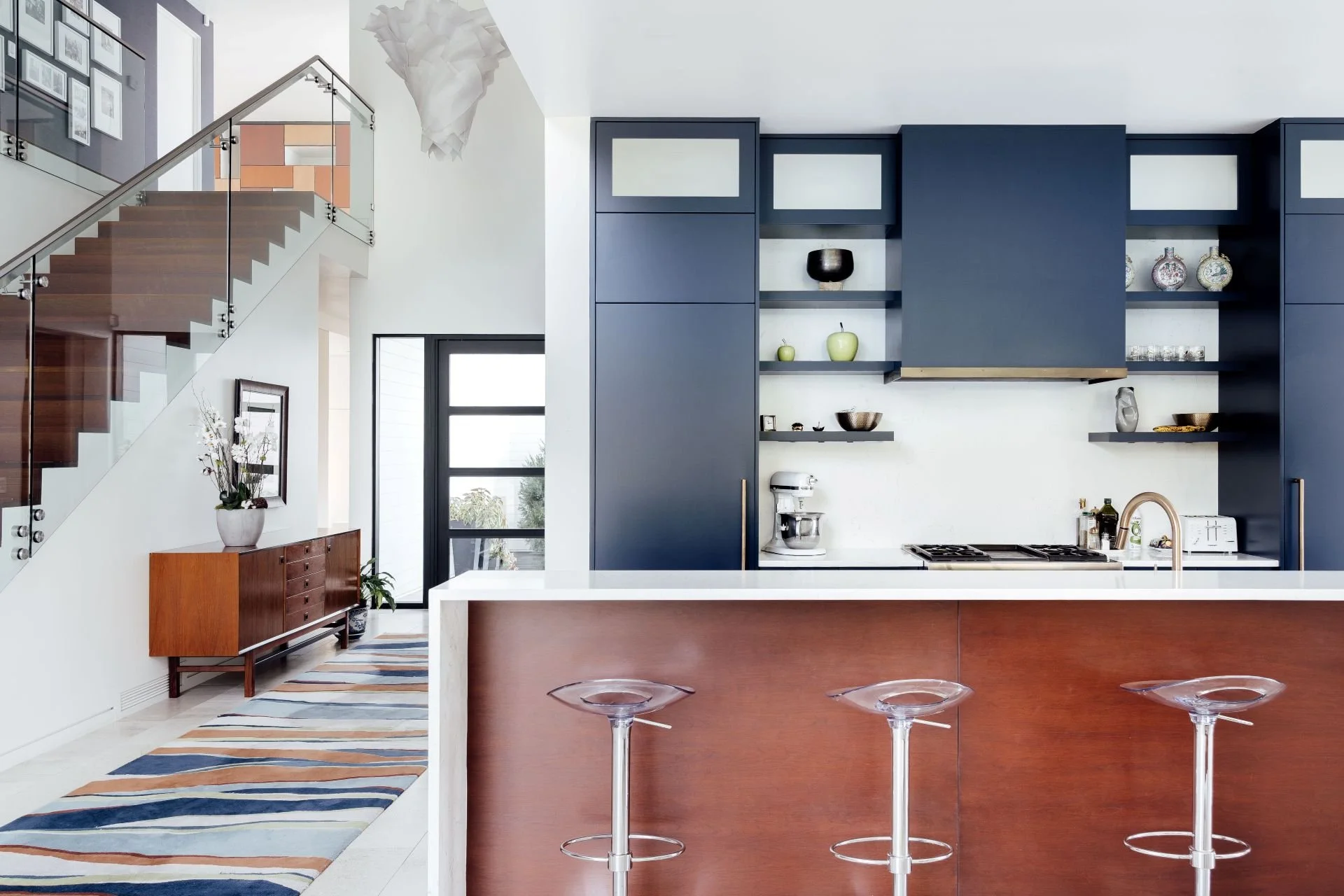 Kitchen and interior hall of modern farmhouse designed by Sparano + Mooney Architecture.
