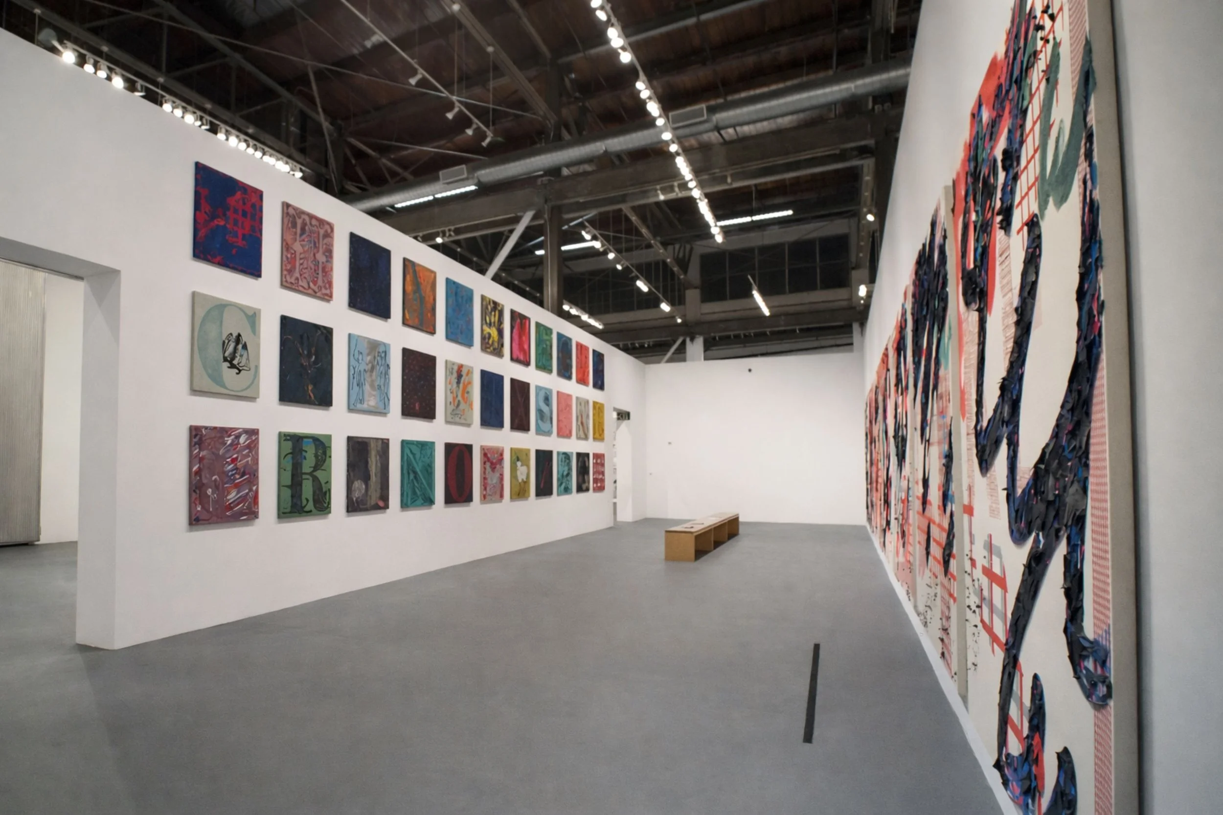 Installation view of Owens series of colorful alphabet square panels with large scale paintings adjacent designed by Sparano + Mooney Architecture