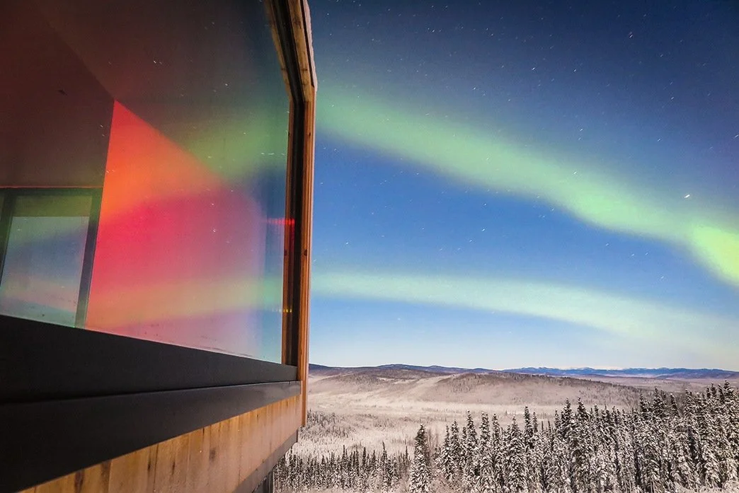 Aurora Borealis reflected in Juneau Aurora villa window designed by Sparano + Mooney Architecture