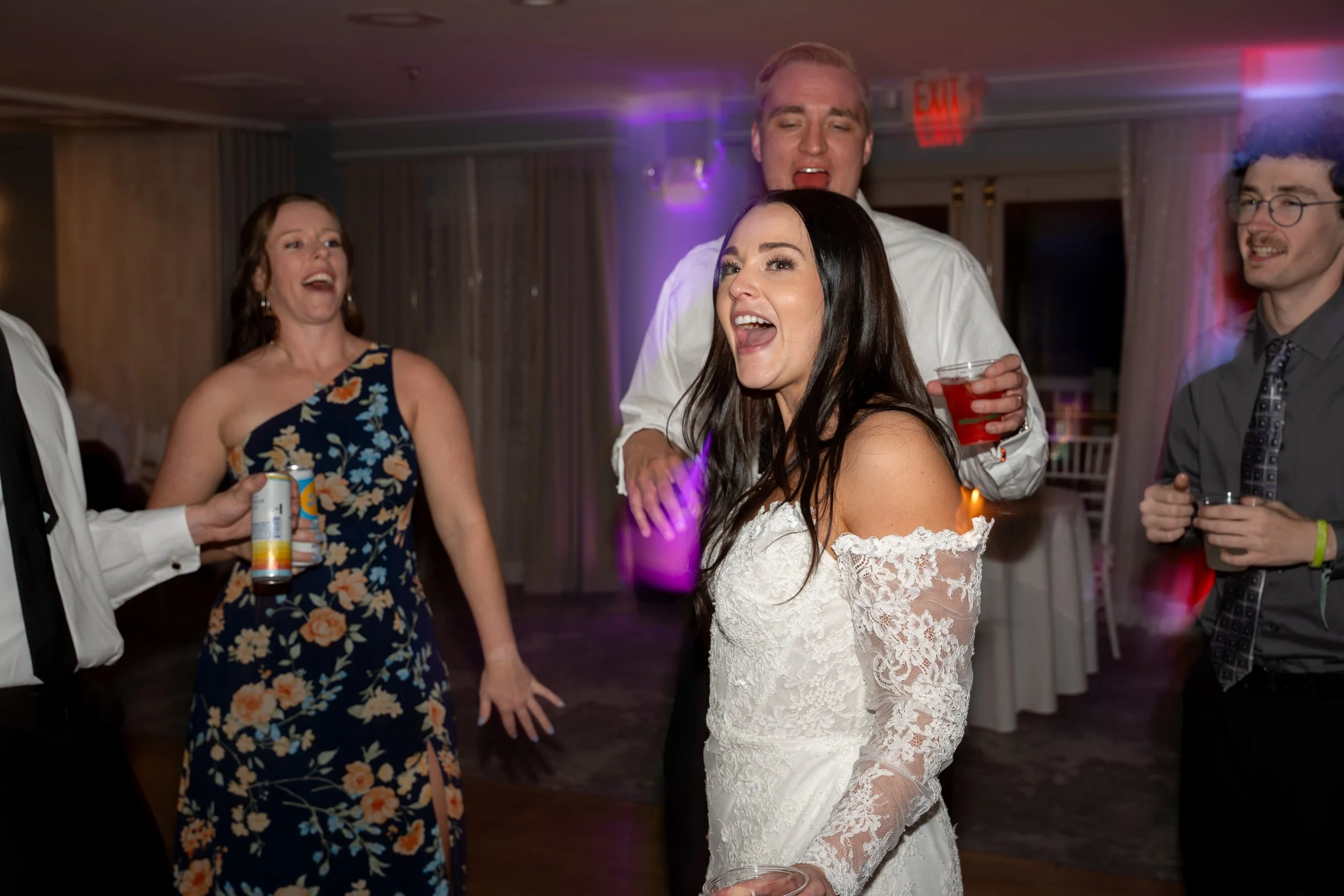 People dancing and laughing during a wedding at Red Jacket Resort in Cape Cod. 