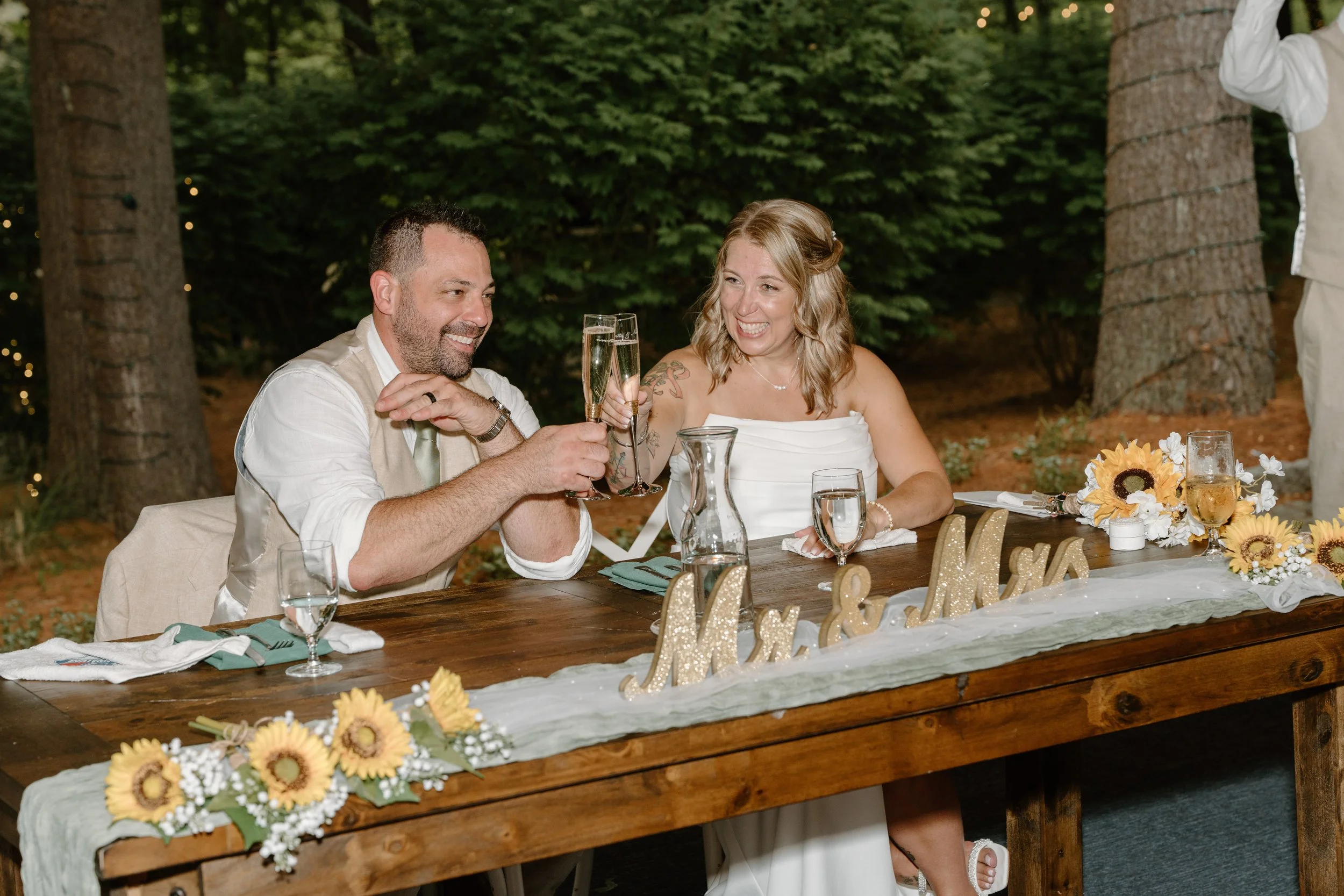 A couple, likely newlyweds, celebrating at a wedding reception for a wedding at Tunxis Country Club in Connecticut. 