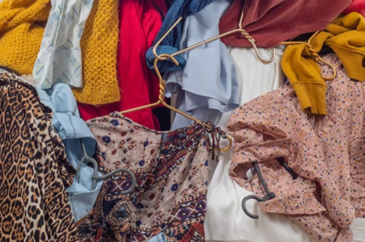 Pile of like new clothes on hangers with Tersus Solutions