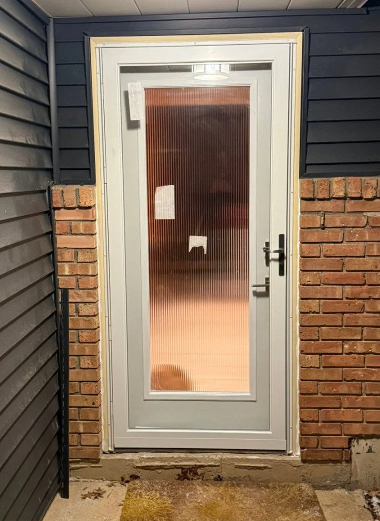 Entry door replacement in a brick opening — after