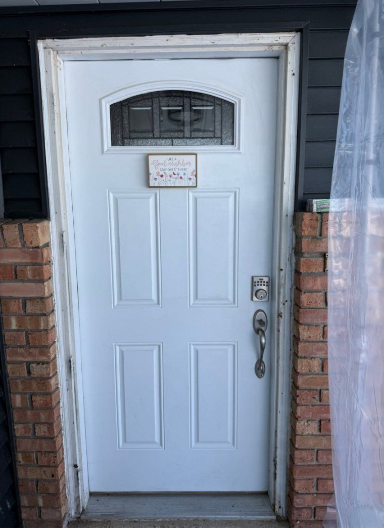 Entry door replacement in a brick opening — before