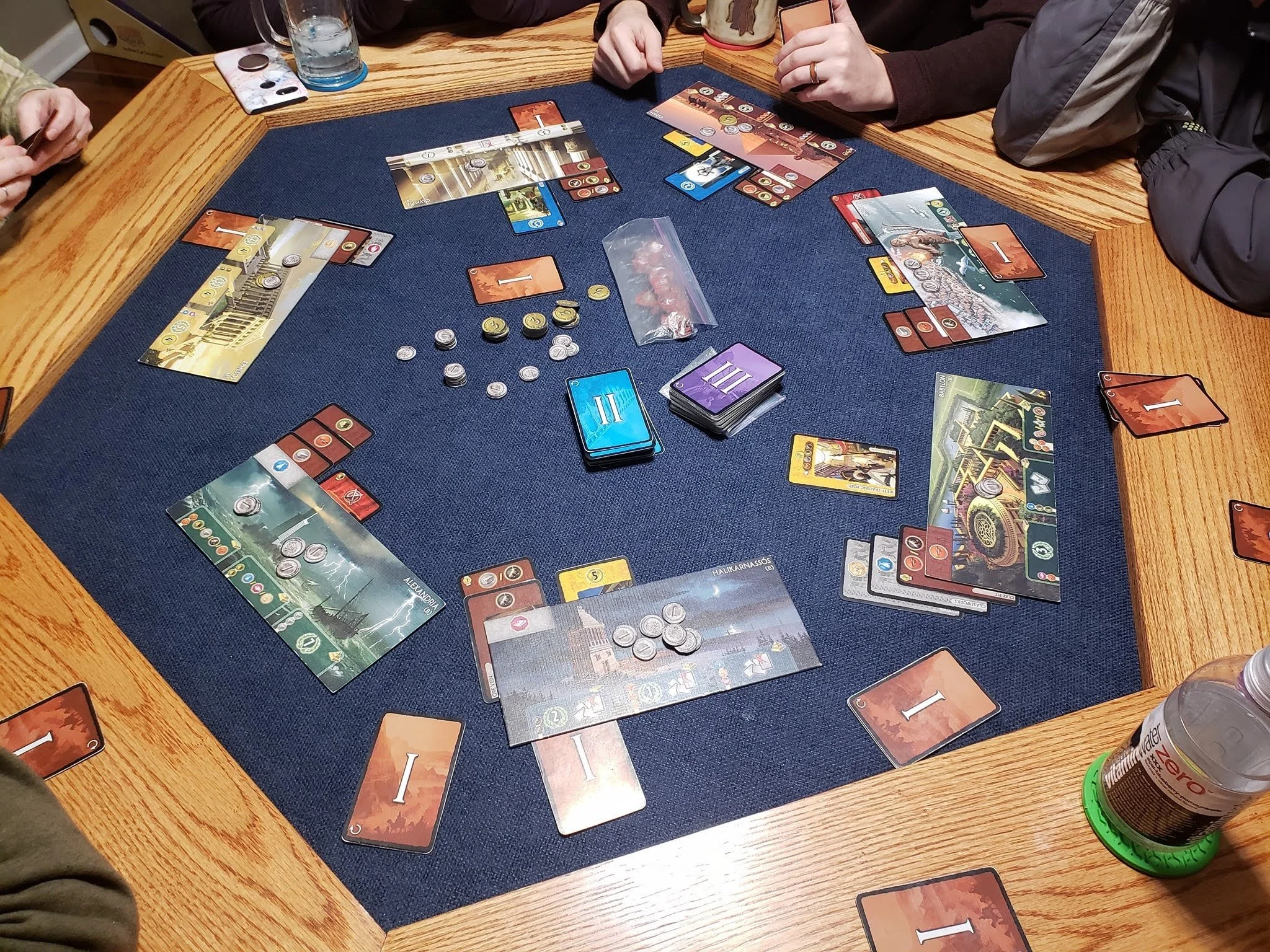 The same game table in use — felt top, room for six