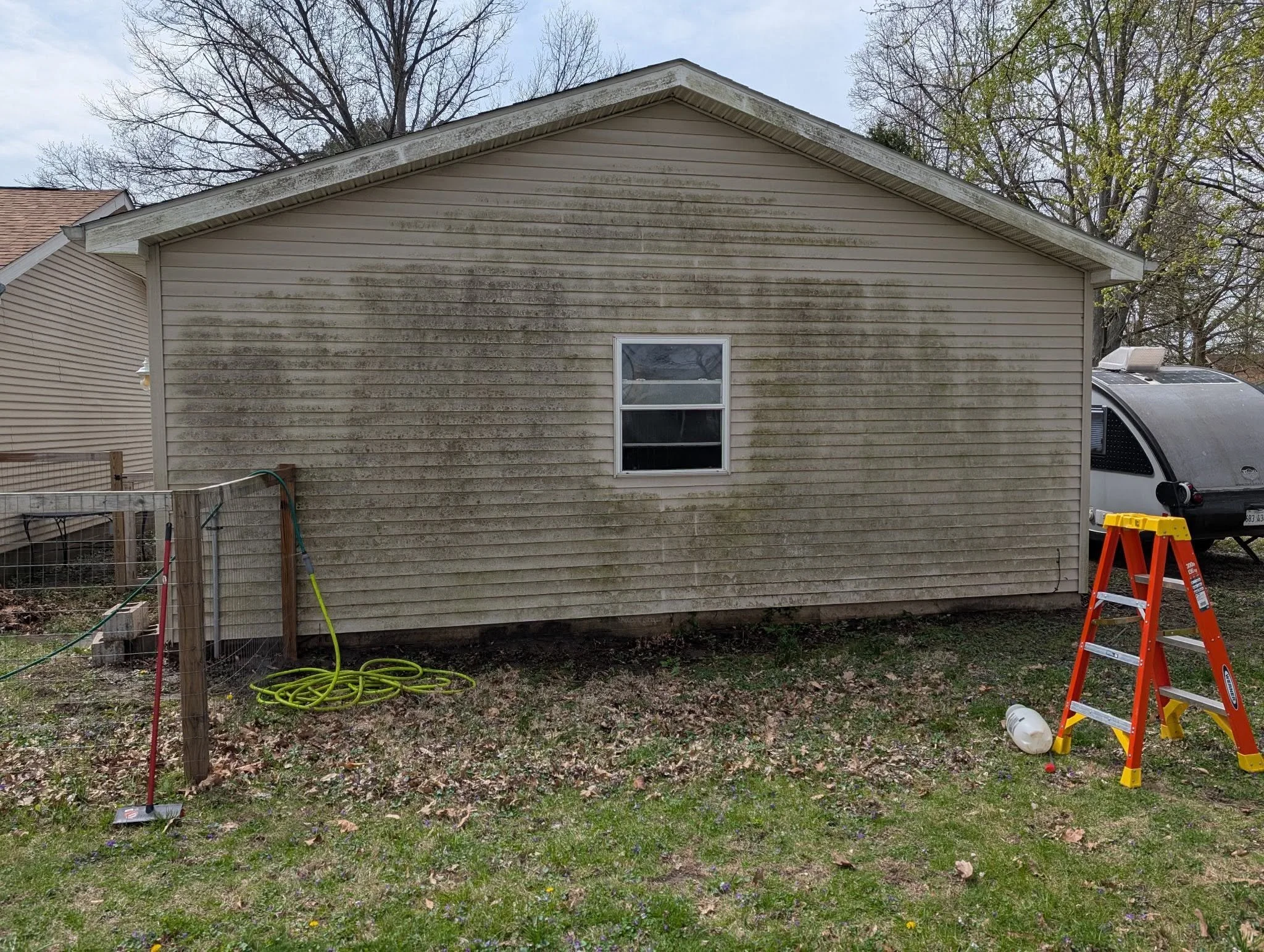 House siding before — green and streaked