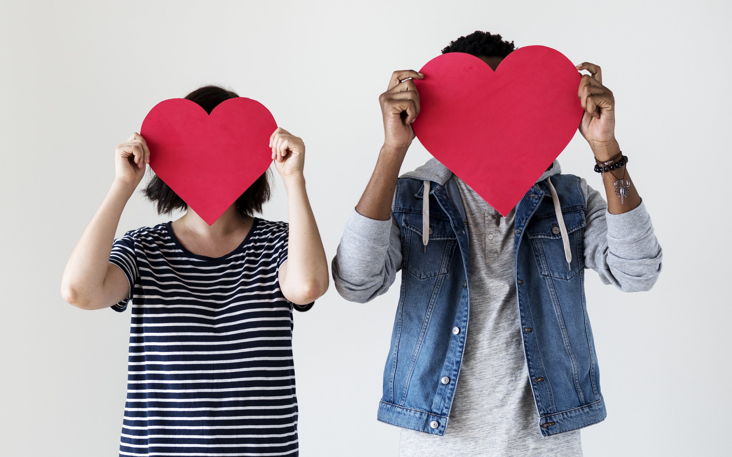 happy-couple-holding-red-heart-icons.jpg