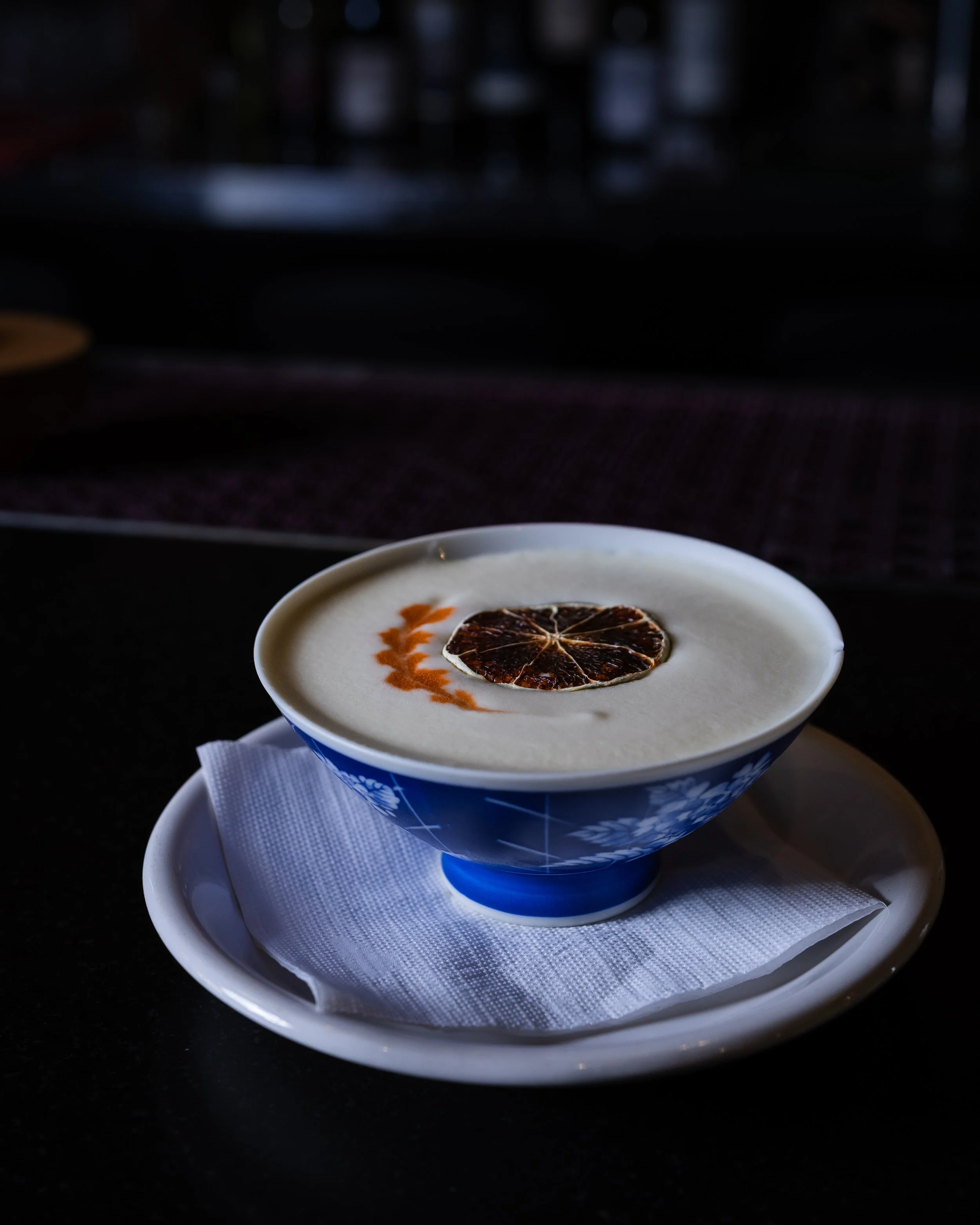 pisco sour with passion fruit, with serve in traditional drinking bowl from western countries.