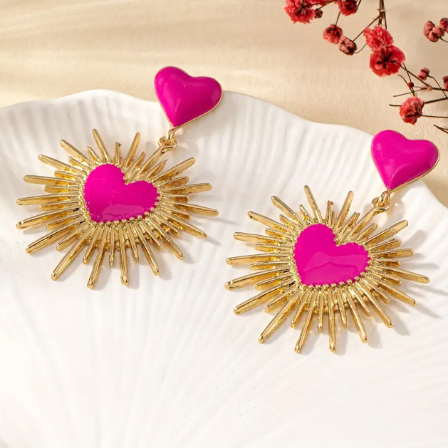 Elevate your style with Mozzimo Jewelry's Gold Plated Pink Sunburst Dangle Statement Earrings, a vibrant and eye-catching accessory. Shop now for a bold look!
