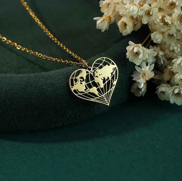 Embrace your love for travel with this exquisite Gold Plated Laser Cut World Globe Heart Pendant Necklace.