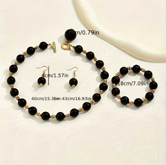 Elevate your look with Mozzimo Jewelryβs black beaded gold-plated necklace, bracelet, and earring set β a bold, modern statement in timeless elegance.