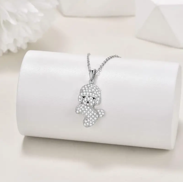 Celebrate your love for poodles with this Sterling Silver Poodle Pendant Necklace, a sparkling and stylish accessory—available now at Mozzimo Jewelry.