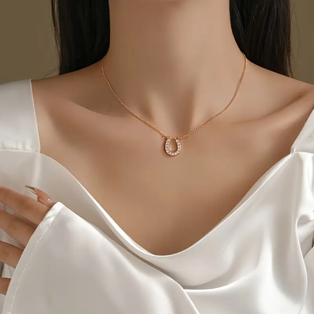 Add a touch of luck and luxury with the Gold Plated Mini White Gemstone Encrusted Horseshoe Pendant Charm Necklace from Mozzimo Jewelry.