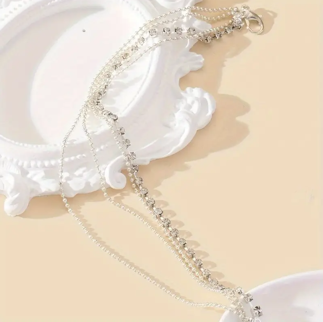 Shop the stunning 4 Layer Sterling Silver Thin Rhinestone Foot Anklets Ankle Bracelets at Mozzimo Jewelry for a touch of sparkle and elegance to your summer style.