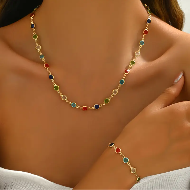 Add a vibrant touch to your style with this gold plated colorful gemstone necklace and bracelet set β a trending favorite at Mozzimo Jewelry.
