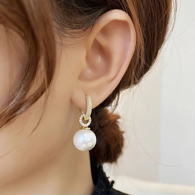 Enhance your elegance with these Gold Plated Rhinestone Encrusted Faux Pearl Mini Hoop Earrings.