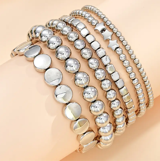 Elevate your stack game with this 6-piece sterling silver beaded bracelet set featuring stars, circles, and squares.