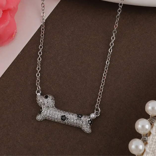 Show your love for pets with the Sterling Silver Rhinestone Encrusted Spotted Dog Pendant Necklace, a playful and elegant accessory—available now at Mozzimo Jewelry.