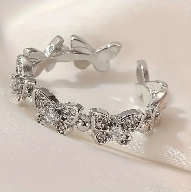 Adorn your fingers with the Sterling Silver Rhinestone Encrusted Connected Butterflies Adjustable One Size Ring – a dazzling, delicate piece.