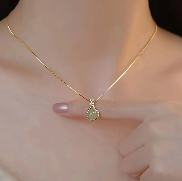 Embrace elegance with the Gold-Plated Mini Teardrop Light Green Jade Pendant Necklace, a timeless symbol of luck and beauty—available now at Mozzimo Jewelry.