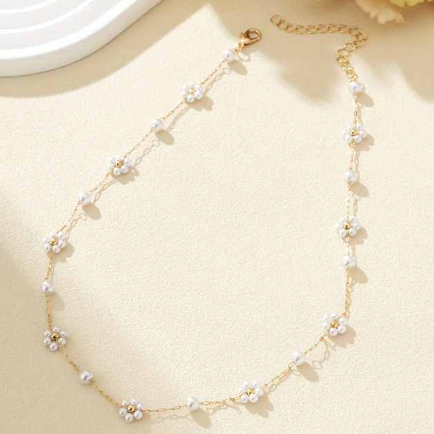 Elegant and dainty, this gold-plated necklace features mini faux pearl flower charms on a fine chain—perfect for layering or solo wear.