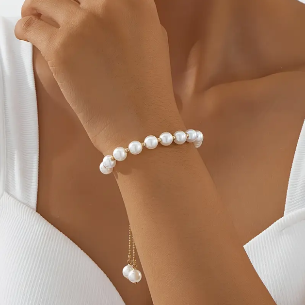 Elevate your style with Mozzimo Jewelry’s Gold Plated White Faux Pearl Adjustable Bracelet—classic pearls on a gold adjustable chain—available now at www.mozzimojewelry.com.