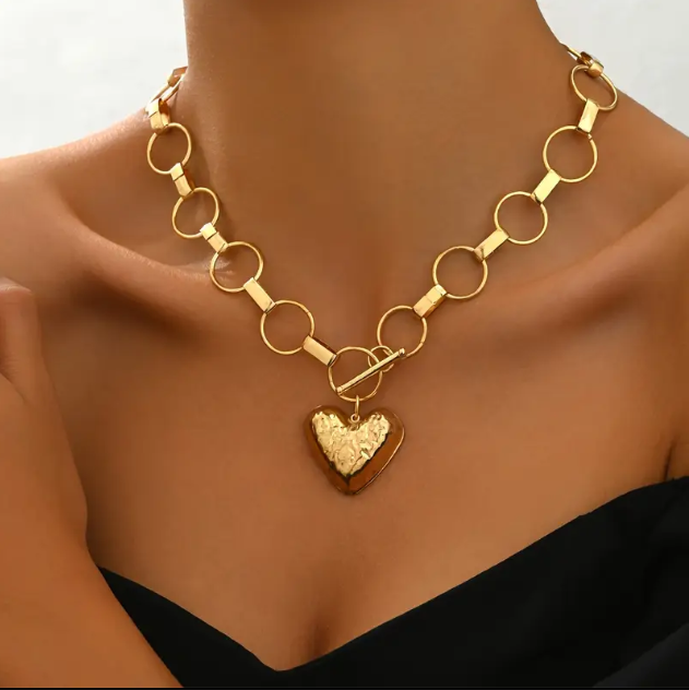 Turn heads with the Gold Plated Rusted Oversize Chain Links Heart Pendant Statement Necklace from Mozzimo Jewelry—an edgy, bold accessory perfect for elevating any outfit.