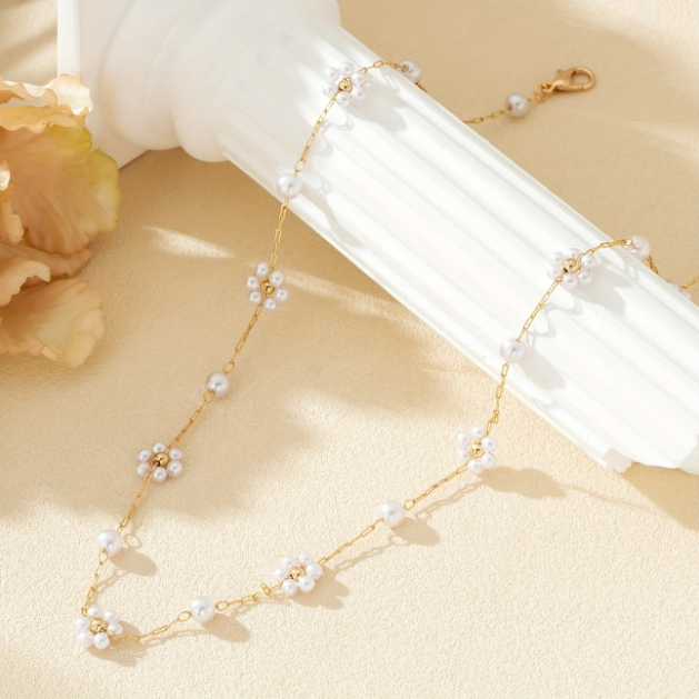Elegant and dainty, this gold-plated necklace features mini faux pearl flower charms on a fine chain—perfect for layering or solo wear.