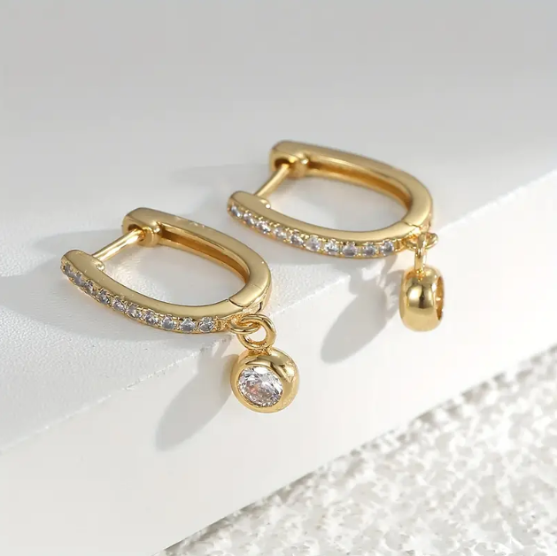Elegant gold-plated rhinestone mini hoops with white gemstone drops – the perfect balance of sparkle, charm, and modern flair.