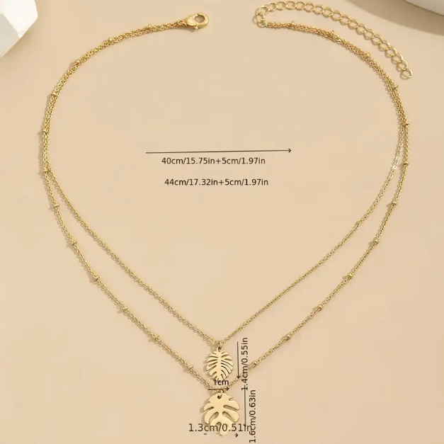 Embrace tropical vibes with our Gold Plated Double Layer Tropical Leaf Fine Necklace, a dainty yet bold layered piece perfect for elevating any look.